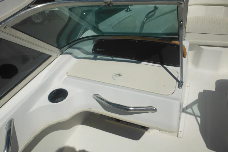 Slide: The Image of 2000 Boston Whaler 18 Ventura Bowrider interior with windshield and seating area. - 21