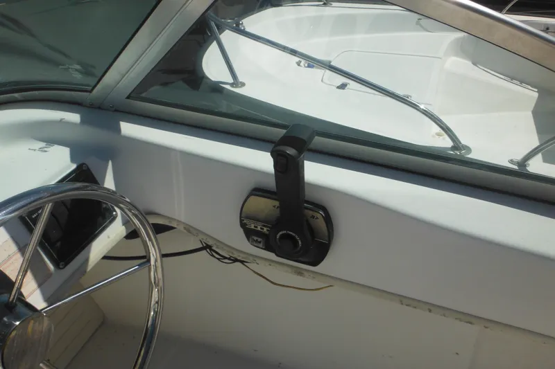 Slide: The Image of 2000 Boston Whaler 18 Ventura Bowrider steering wheel and control panel. - 24