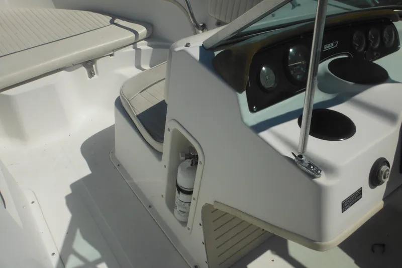 Slide: The Image of 2000 Boston Whaler 18 Ventura Bowrider interior with dashboard and seating area. - 26