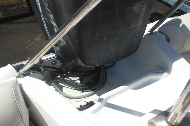 Slide: The Image of 2000 Boston Whaler 18 Ventura Bowrider engine area with visible cables and seating. - 30