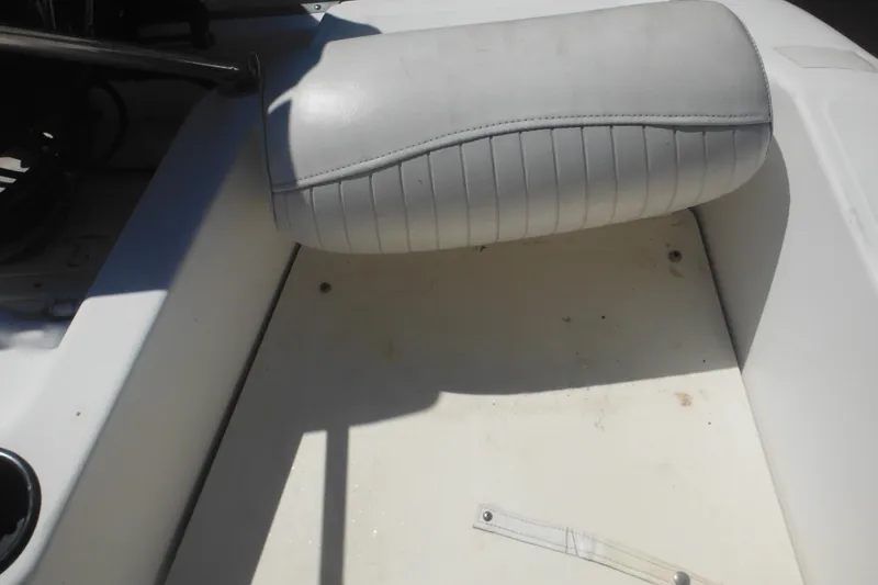 Slide: The Image of Interior of 2000 Boston Whaler 18 Ventura Bowrider, featuring white seating and flooring. - 32