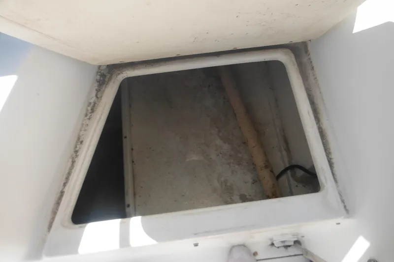 Slide: The Image of Storage compartment of a 2000 Boston Whaler 18 Ventura Bowrider boat. - 33