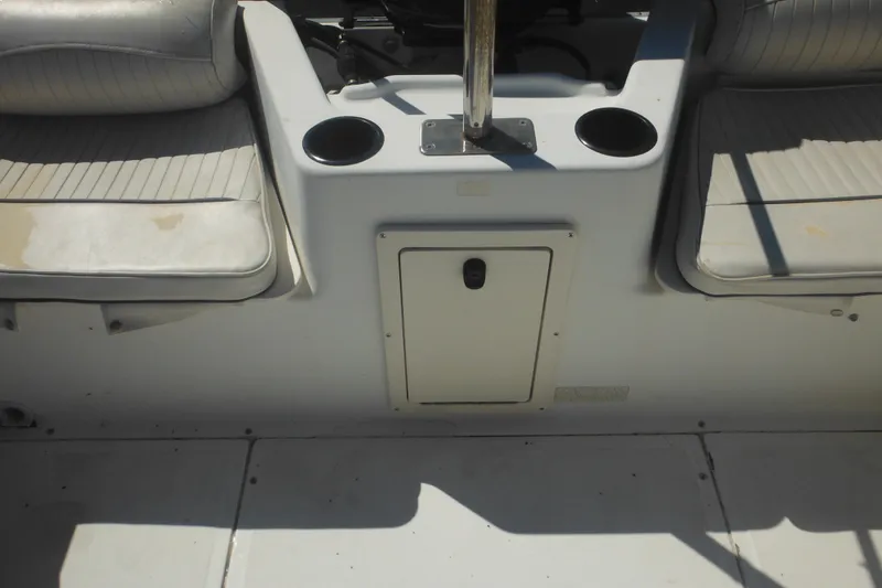 Slide: The Image of 2000 Boston Whaler 18 Ventura Bowrider interior with seating and cup holders. - 36