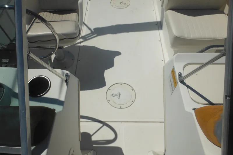 Slide: The Image of Interior view of a 2000 Boston Whaler 18 Ventura Bowrider boat cockpit. - 38