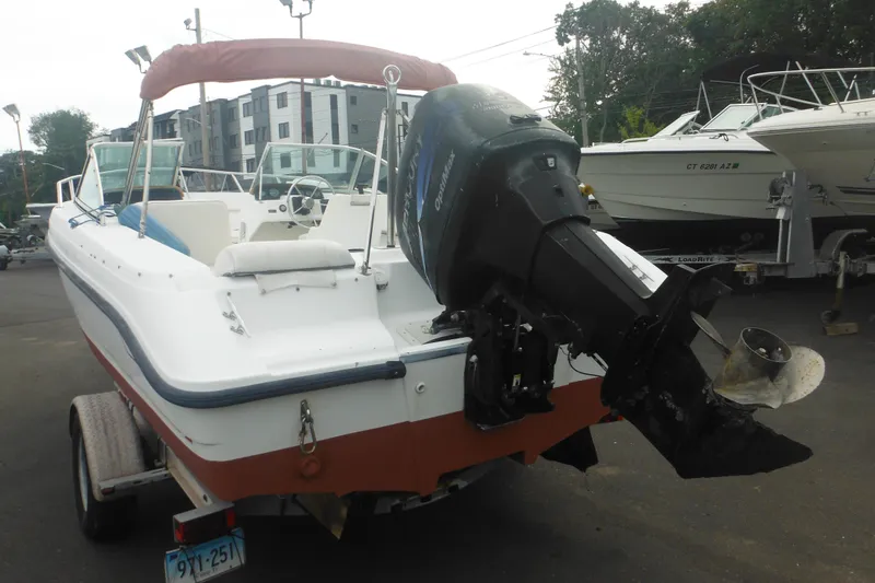 Slide: The Image of 2000 Boston Whaler 18 Ventura Bowrider with outboard motor on trailer. - 4