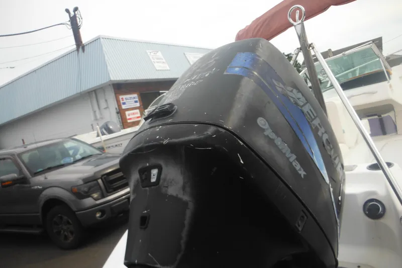 Slide: The Image of 2000 Boston Whaler 18 Ventura Bowrider with Mercury outboard motor in a marina setting. - 7