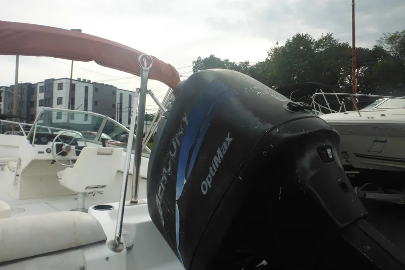 Slide: The Image of 2000 Boston Whaler 18 Ventura Bowrider with Mercury OptiMax engine, docked outdoors. - 8