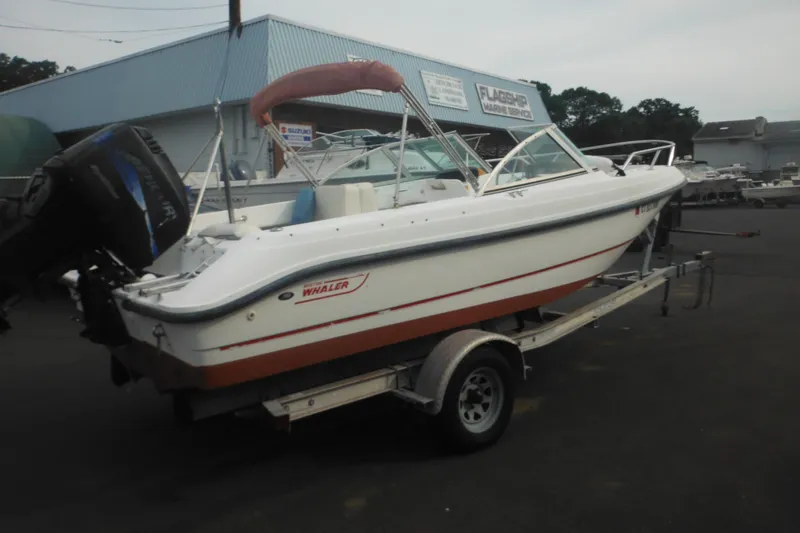 Slide: The Image of 2000 Boston Whaler 18 Ventura Bowrider on trailer at marina, side view. - 9