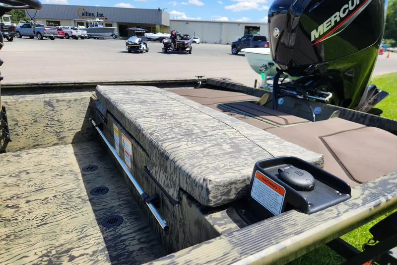 Slide: The Image of 2026 Tracker Grizzly 1860 CC boat with camo seating and Mercury engine in a dealership lot. - 11