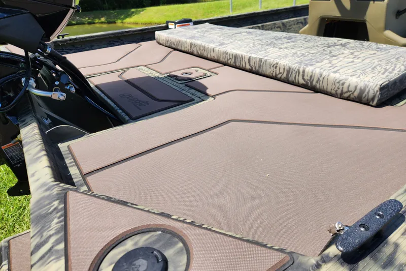 Slide: The Image of 2026 Tracker Grizzly 1860 CC boat interior with camo seating and storage compartments. - 12