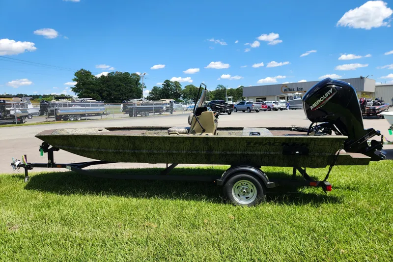 Slide: The Image of 2026 Tracker Grizzly 1860 CC boat on trailer, parked outdoors under blue sky. - 5