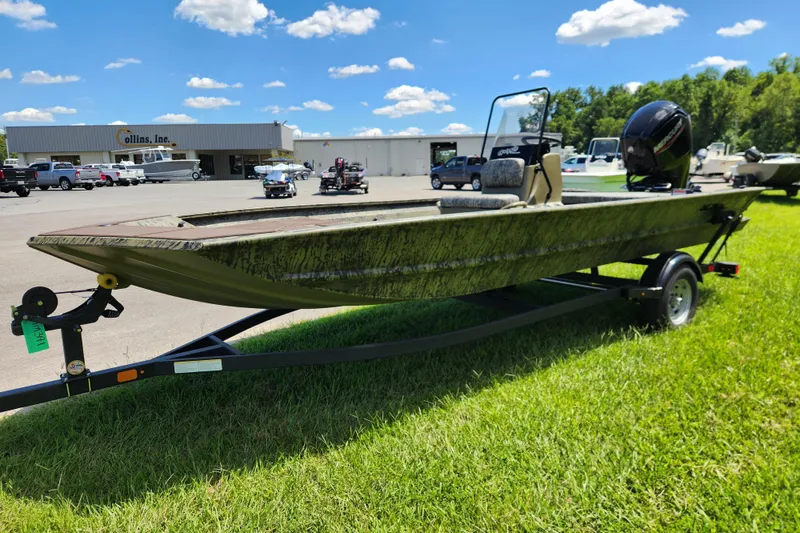 Slide: The Image of 2026 Tracker Grizzly 1860 CC boat on trailer, parked on grass near dealership. - 6