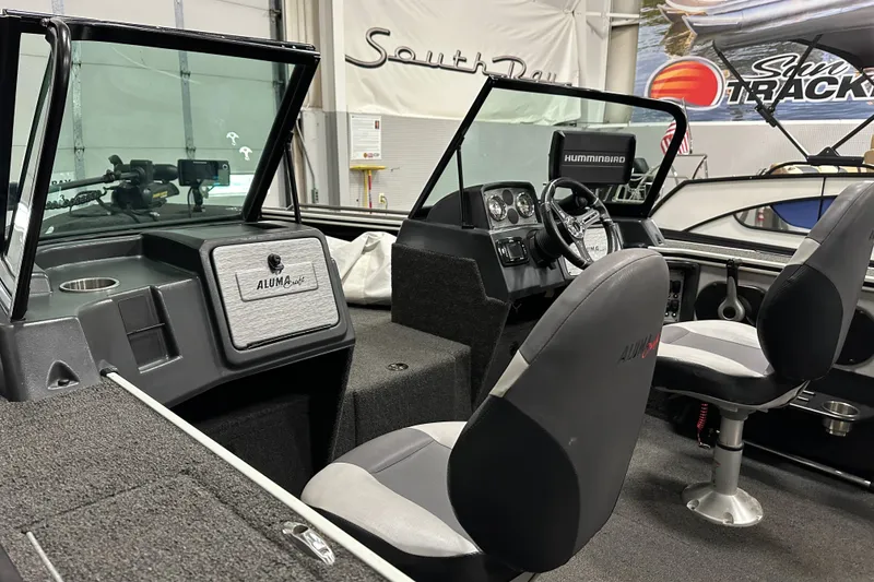 Slide: The Image of 2017 Alumacraft Trophy 185 boat interior with steering console and seating. - 11