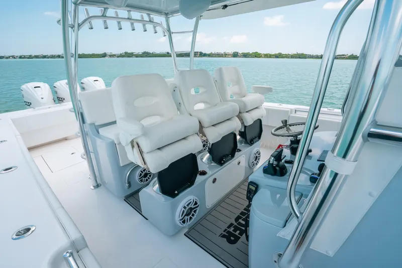 Slide: The Image of 2025 Contender 44 ST boat interior with luxurious seating and advanced controls on open water. - 19