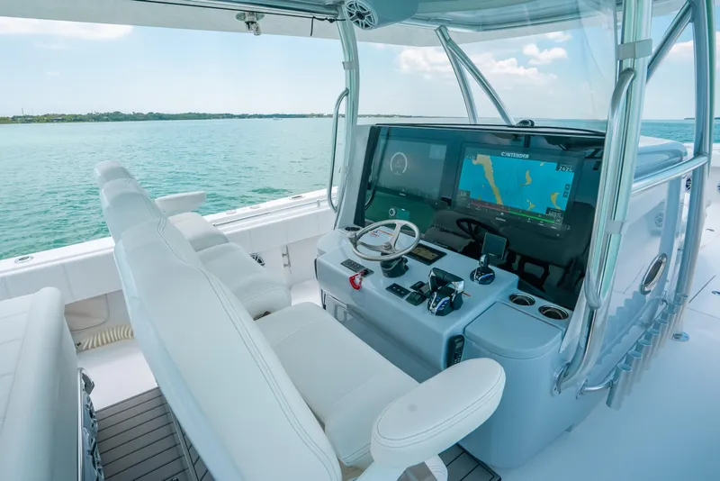 Slide: The Image of 2025 Contender 44 ST boat cockpit with advanced navigation system and luxurious seating. - 20