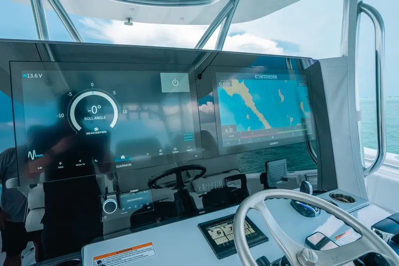 Slide: The Image of Dashboard of 2025 Contender 44 ST boat with navigation and control screens. - 22