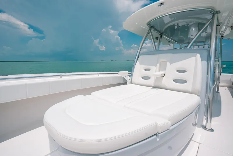 Slide: The Image of 2025 Contender 44 ST boat with luxurious white seating on a sunny day. - 25