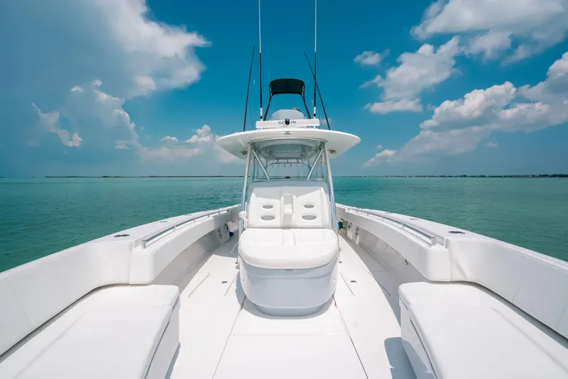 Slide: The Image of 2025 Contender 44 ST boat on calm ocean under blue sky. - 26