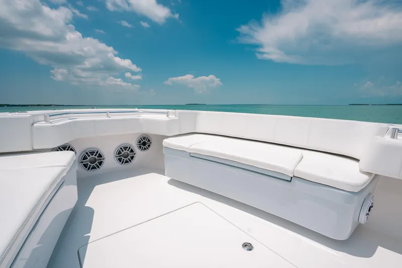 Slide: The Image of Luxurious seating on 2025 Contender 44 ST boat under clear blue sky. - 28