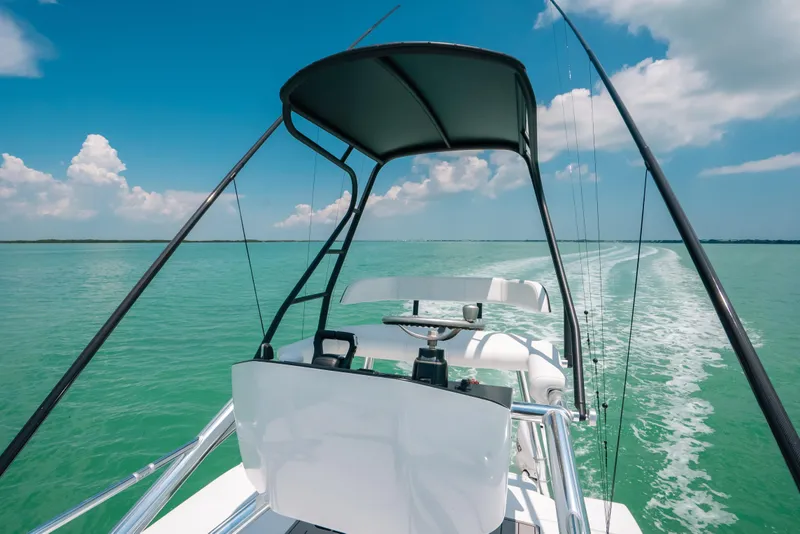 Slide: The Image of 2025 Contender 44 ST boat cruising on turquoise waters under a clear blue sky. - 29