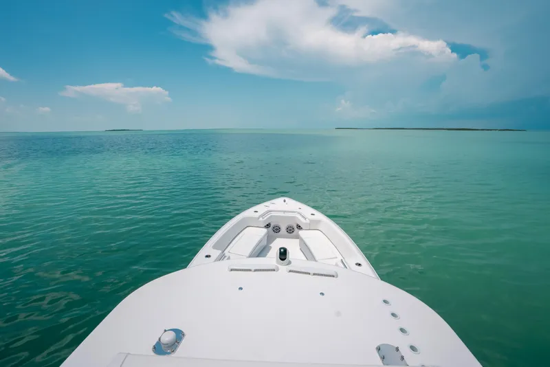 Slide: The Image of Bow of 2025 Contender 44 ST boat on calm turquoise sea under blue sky. - 32
