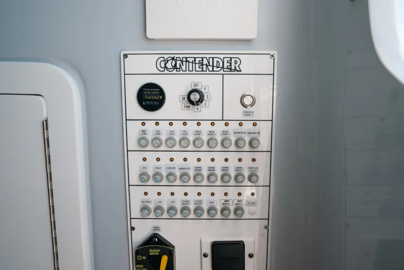 Slide: The Image of Control panel of 2025 Contender 44 ST boat with switches and indicators. - 37