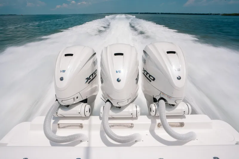Slide: The Image of Triple Yamaha V8 outboard engines powering a 2025 Contender 44 ST boat at high speed. - 4