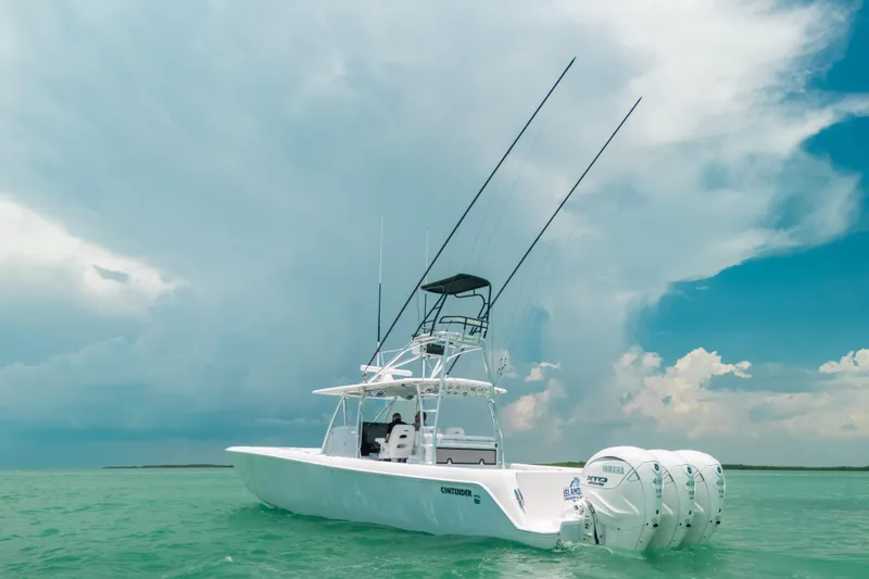 Slide: The Image of 2025 Contender 44 ST boat on turquoise water under cloudy sky. - 9