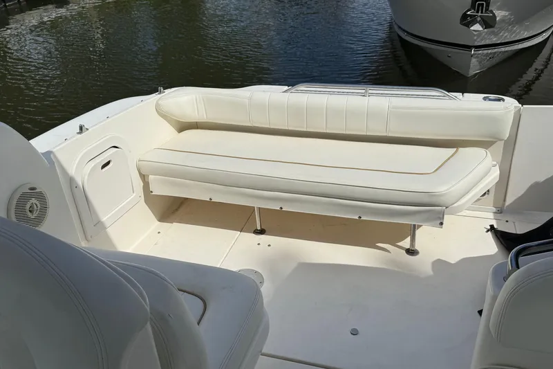 Slide: The Image of 1998 Sea Ray 290 Sundancer boat interior with white seating and water view. - 6