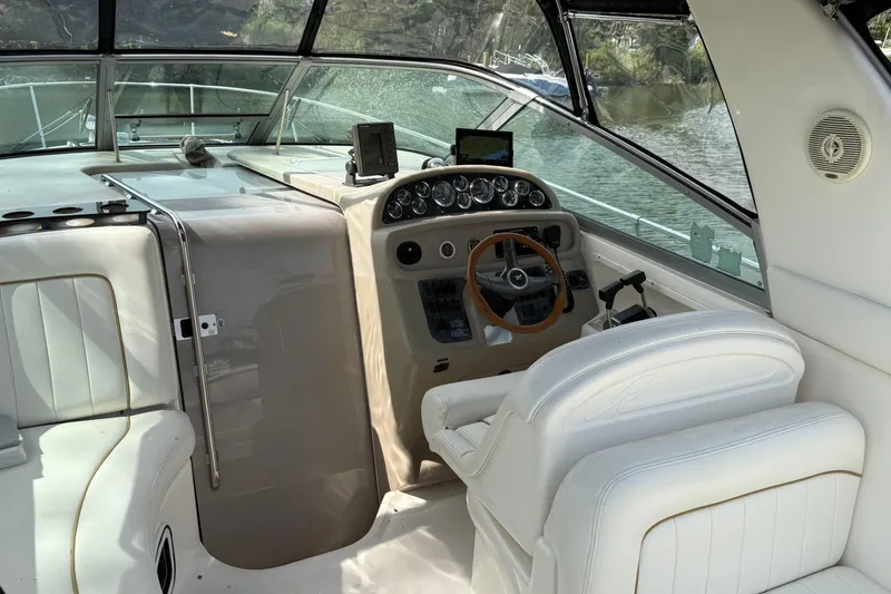 Slide: The Image of 1998 Sea Ray 290 Sundancer cockpit with steering wheel and navigation equipment. - 7