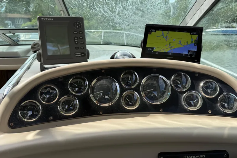 Slide: The Image of Dashboard of a 1998 Sea Ray 290 Sundancer with navigation instruments and gauges. - 8