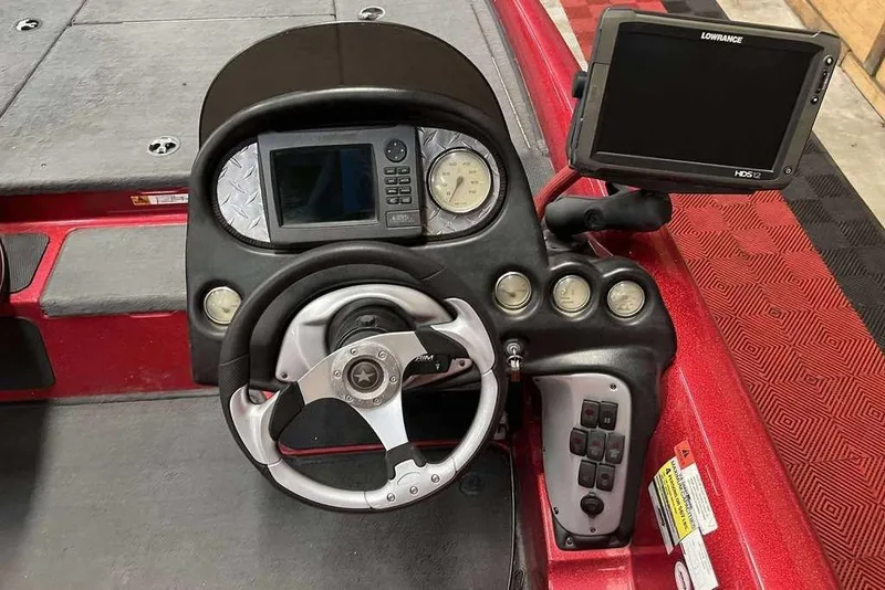 Slide: The Image of 2008 Stratos 294 XL boat dashboard with steering wheel and Lowrance HDS-12 display. - 5
