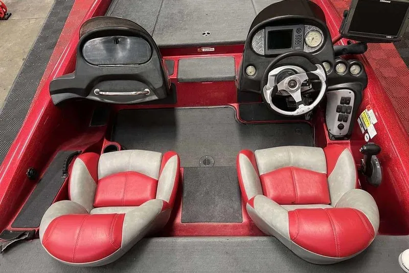 Slide: The Image of 2008 Stratos 294 XL boat interior with red and gray seats, steering console, and dashboard. - 6