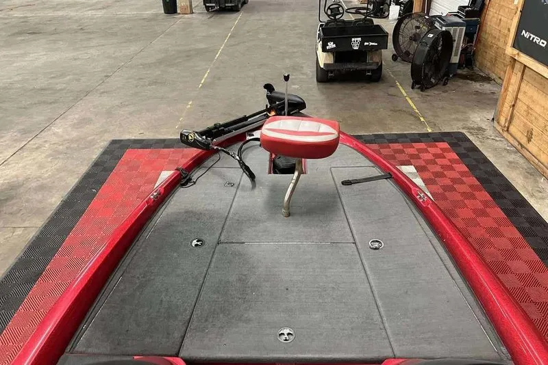 Slide: The Image of 2008 Stratos 294 XL boat interior with red accents and seating in a garage setting. - 7