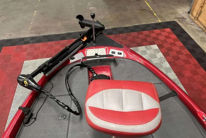 Slide: The Image of 2008 Stratos 294 XL boat interior with red and gray seat and trolling motor. - 9