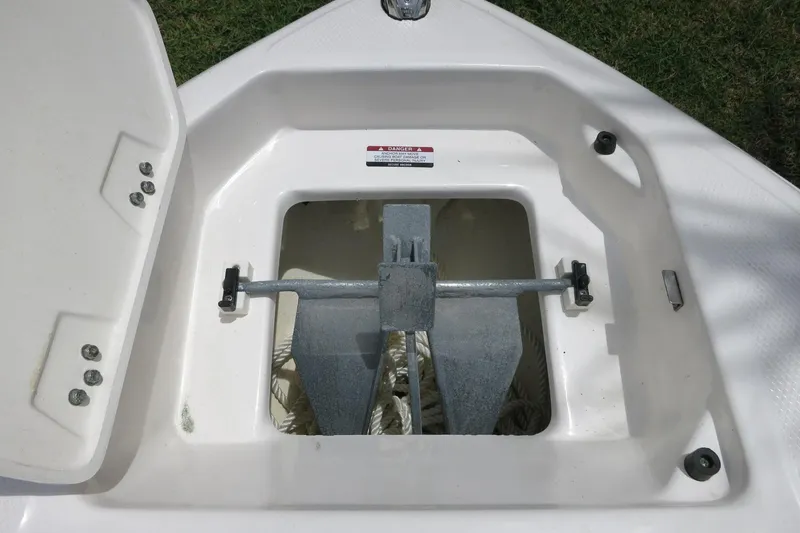 Slide: The Image of 2023 Chaparral 23 SSi OB anchor storage compartment with open hatch. - 12