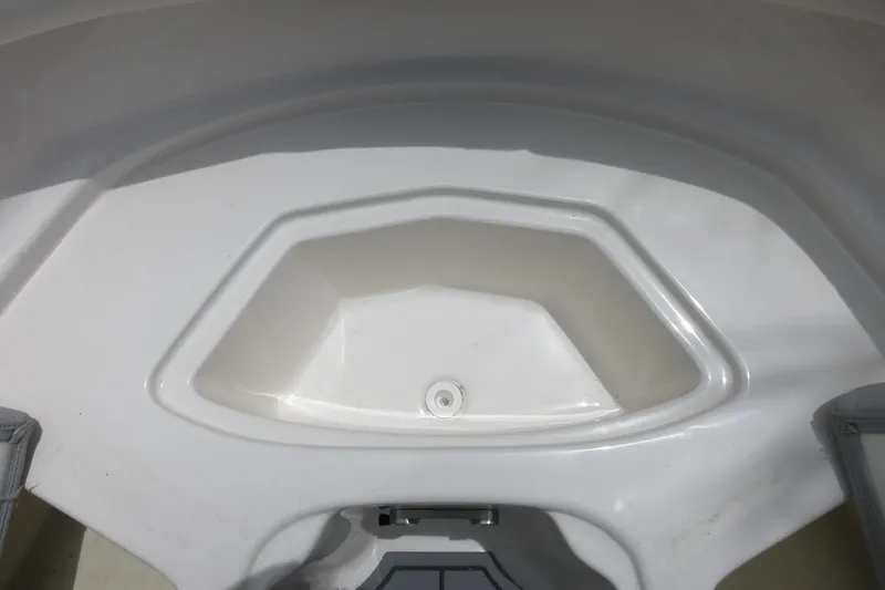 Slide: The Image of 2023 Chaparral 23 SSi OB boat storage compartment, white interior, close-up view. - 13