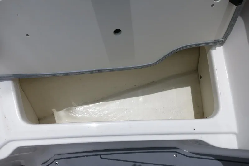 Slide: The Image of Storage compartment of 2023 Chaparral 23 SSi OB boat, open and empty. - 15