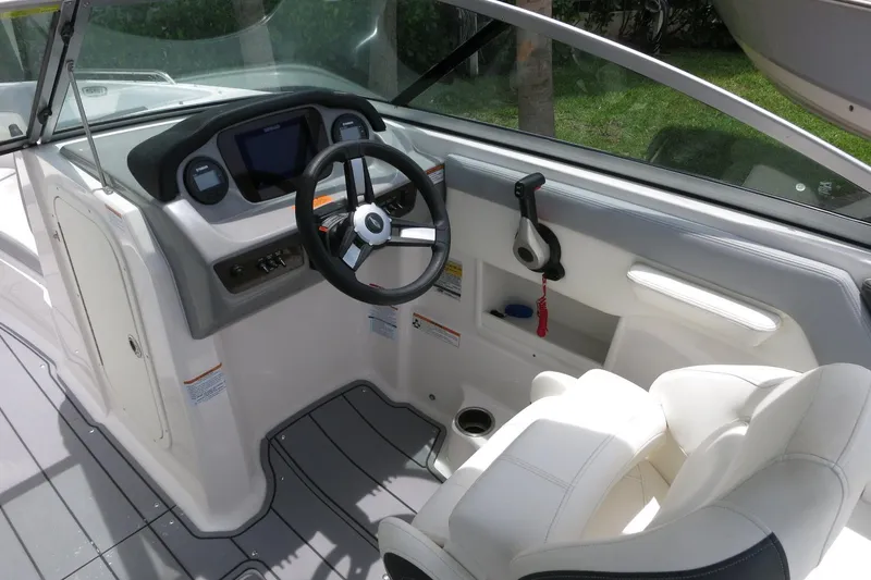 Slide: The Image of 2023 Chaparral 23 SSi OB boat cockpit with steering wheel and control panel. - 19