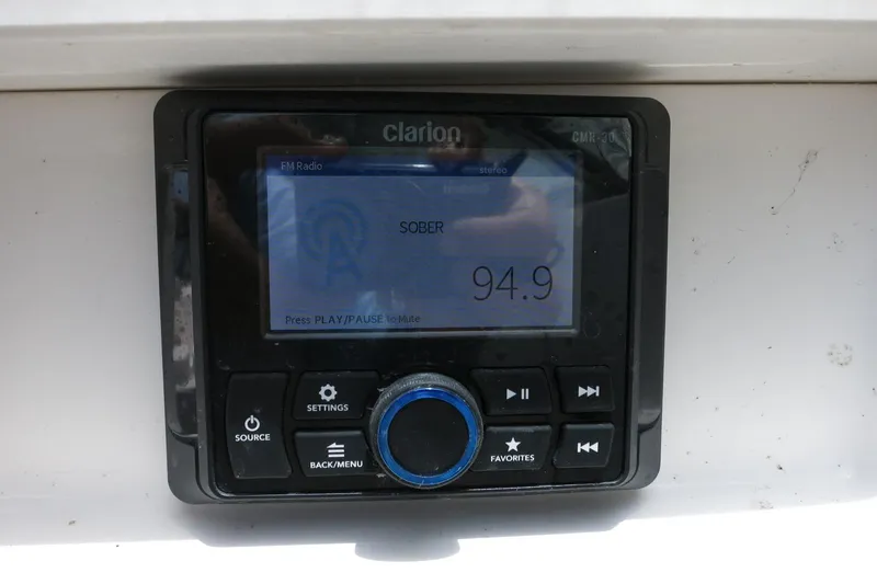 Slide: The Image of Clarion radio display in 2023 Chaparral 23 SSi OB boat, tuned to 94.9 FM. - 21