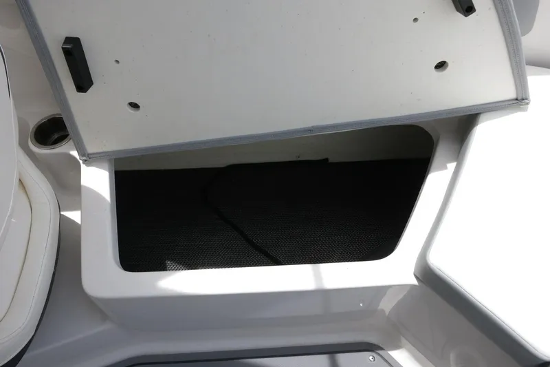 Slide: The Image of Open storage compartment on 2023 Chaparral 23 SSi OB boat. - 28