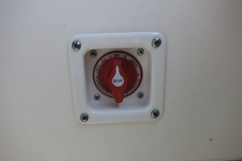 Slide: The Image of Battery switch on 2023 Chaparral 23 SSi OB boat, red knob with white panel. - 35