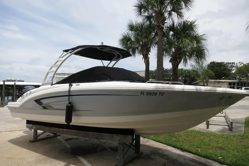 Slide: The Image of 2023 Chaparral 23 SSi OB boat on display with palm trees in the background. - 4