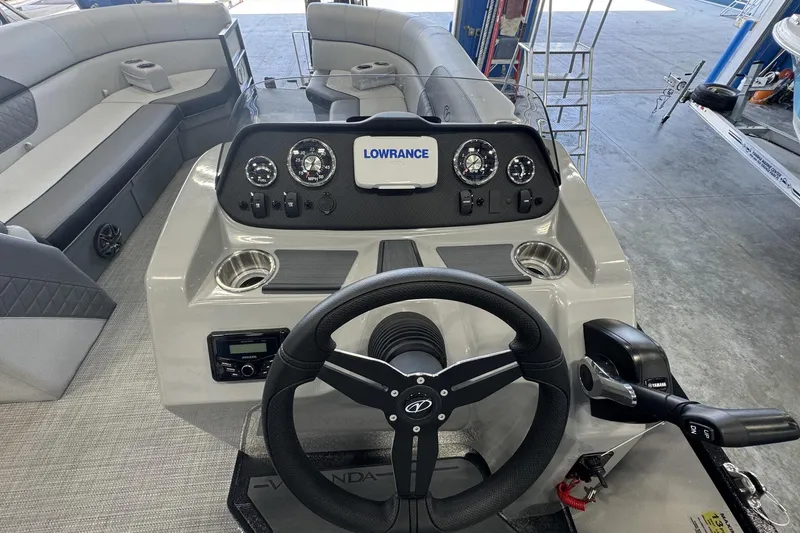 Slide: The Image of 2025 Veranda Vista Sport VS 22 RC boat dashboard with steering wheel and control panel. - 3