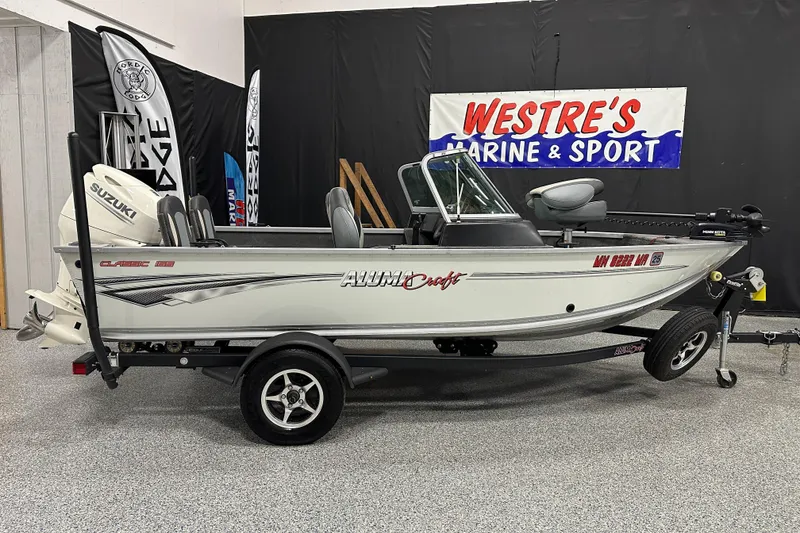 Slide: The Image of 2020 Alumacraft Classic 165 Sport boat displayed at Westre's Marine & Sport showroom. - 0