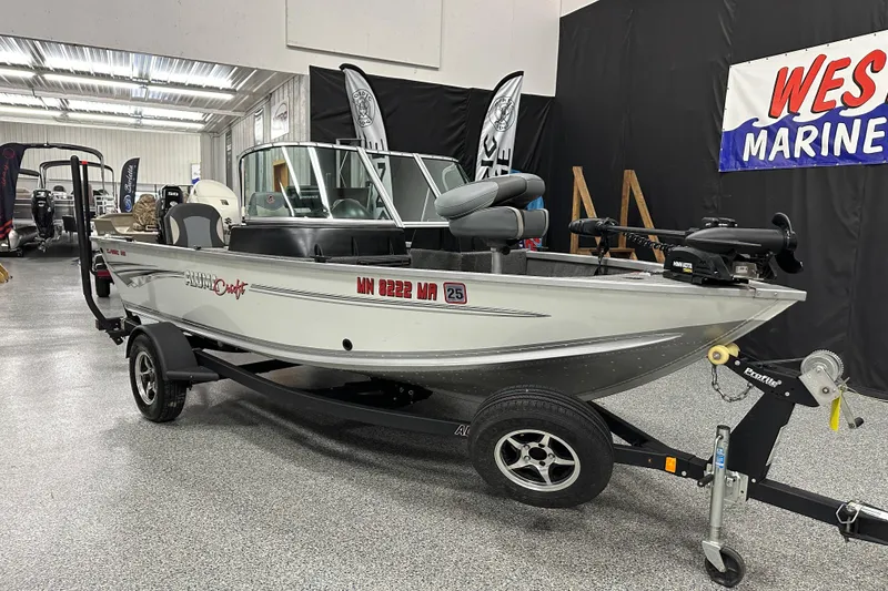 Slide: The Image of 2020 Alumacraft Classic 165 Sport boat on trailer in showroom. - 1