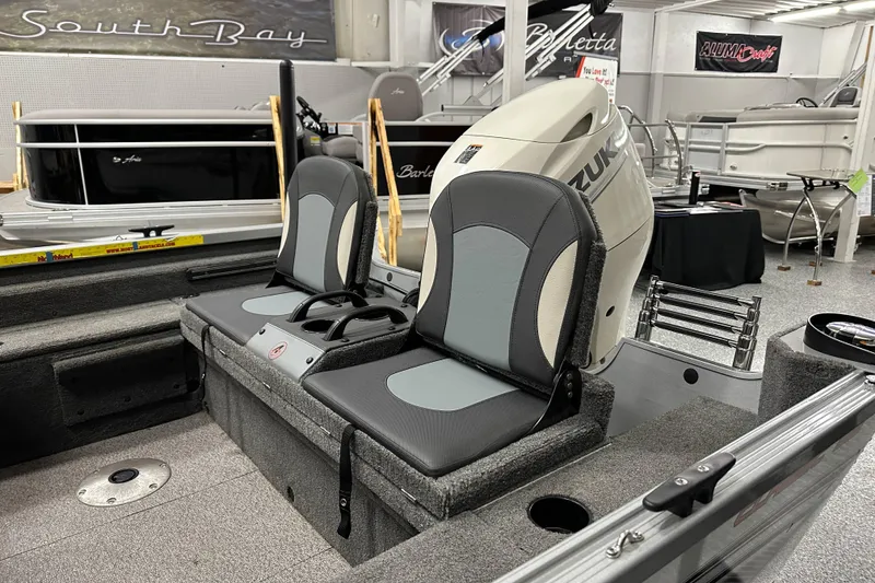 Slide: The Image of 2020 Alumacraft Classic 165 Sport boat interior with Suzuki outboard motor in showroom. - 11