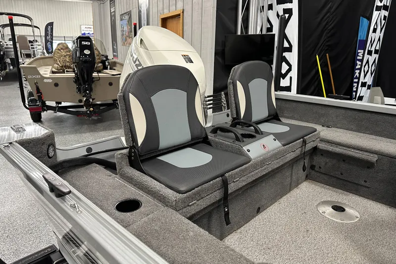 Slide: The Image of 2020 Alumacraft Classic 165 Sport boat interior with dual seats in showroom. - 13