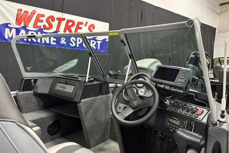 Slide: The Image of 2020 Alumacraft Classic 165 Sport boat interior with steering wheel and control panel. - 14