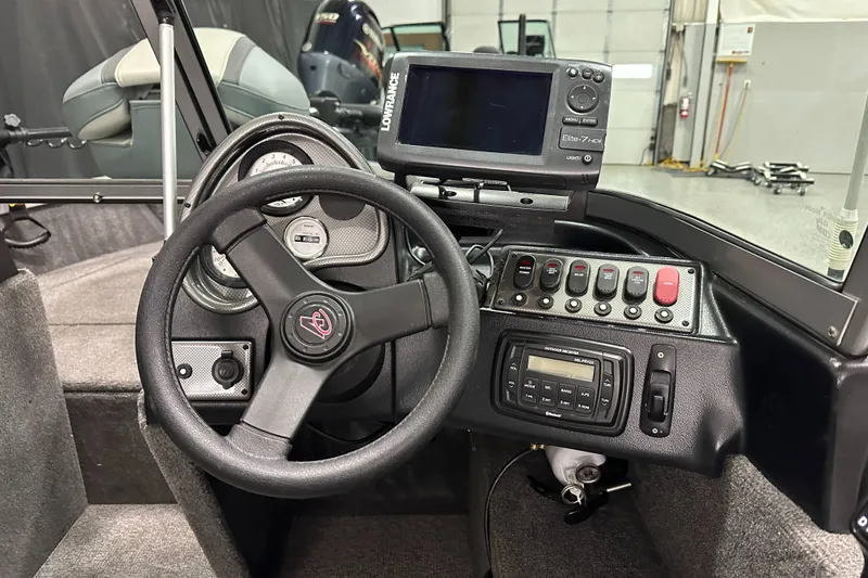 Slide: The Image of 2020 Alumacraft Classic 165 Sport dashboard with steering wheel and electronic controls. - 15